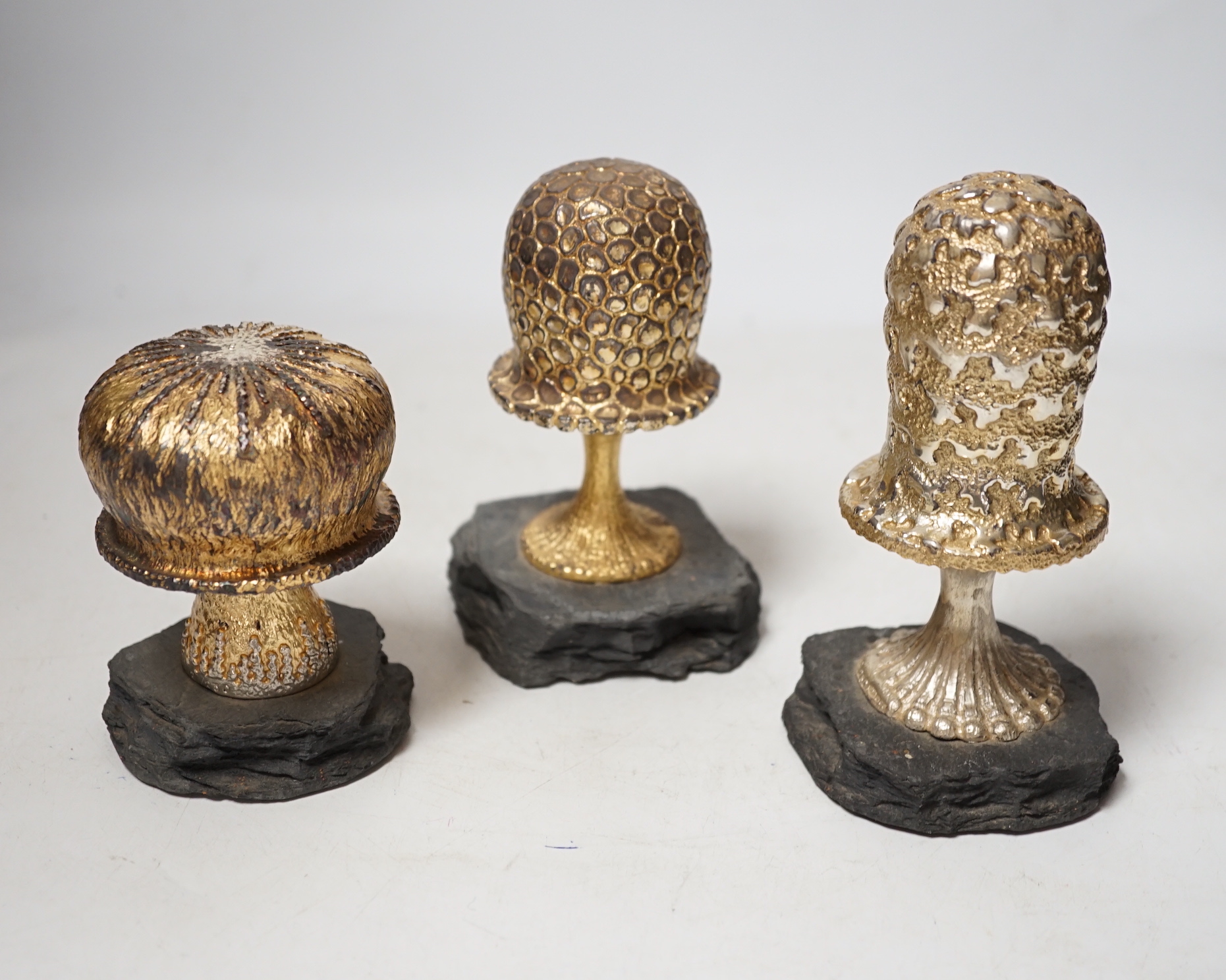 Three Elizabeth II limited edition surprise toadstools, by Christopher Nigel Lawrence, opening to reveal pixies at various pursuits, 1981/82/85, tallest 13.9cm, one cover apparently unmarked, all on simulated rock bases.